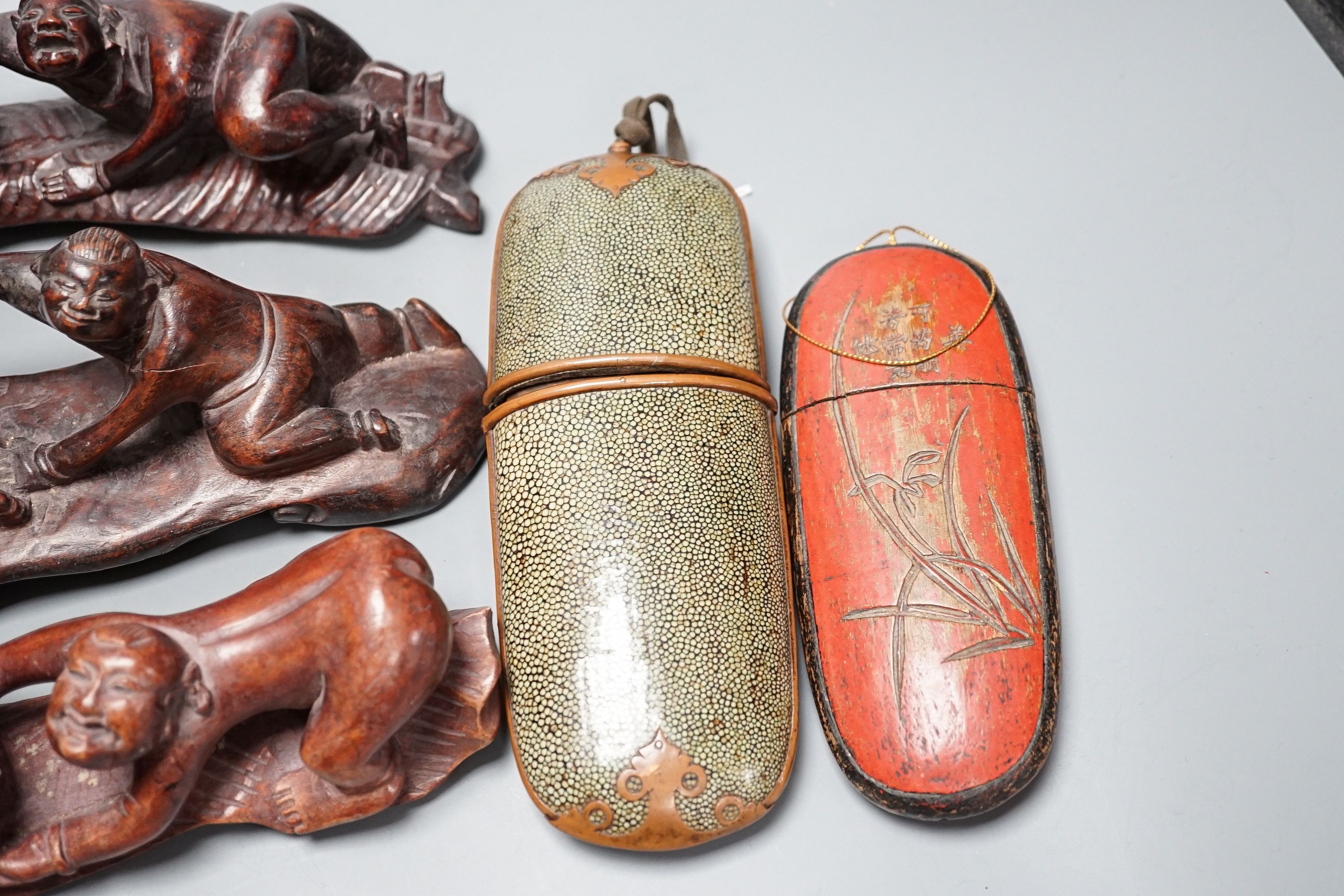 Two Chinese Qing spectacle cases, 19cm, and three hardwood carvings of boys